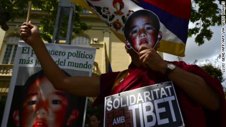 Pro-Tibetan protesters hold pictures of Gendun Cheokyi Nyima (recognized by the Dalai Lama as the 11th Panchen Lama) during a demonstration outside the Chinese consulate in Barcelona on May 17, 2013.