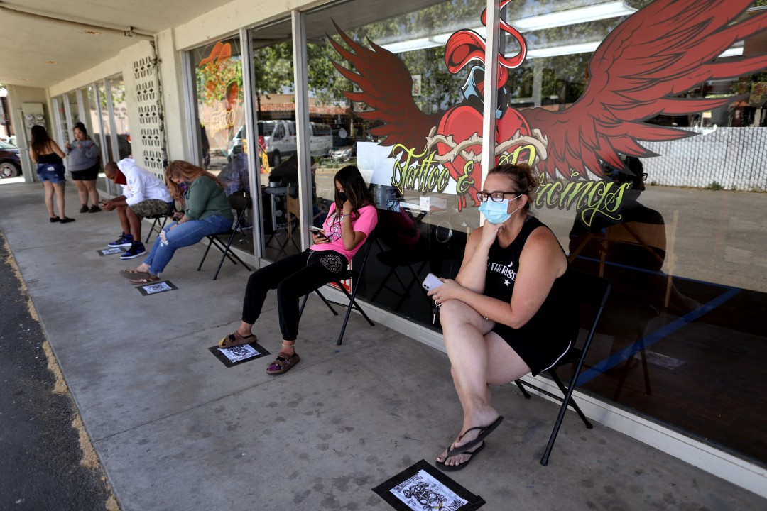Customers wait in line for body piercings at Heart & Soul Tattoo in Yuba City.