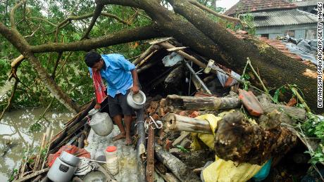 A man rescues belongings from his house damaged by Typhoon Amphan in Midnapore, West Bengal, on May 21, 2020. 