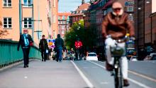 Pedestrians and cyclists cross a bridge in the heart of Stockholm on May 11.