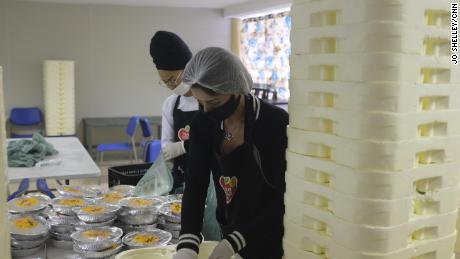 Volunteers prepare around 10,000 meals that are distributed to the Paraisopolis favela residents every day, so they don't have to leave the house to eat.