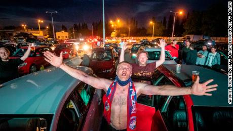 Fans cheered as they watched the Czech first division football match between FC Viktoria Plzen and AC Sparta Prague at a drive-in cinema in Plzen, Czech Republic.