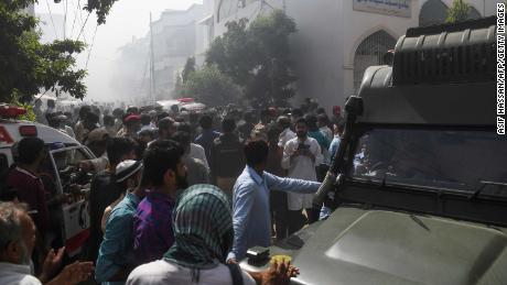 Rescuers and observers gathered near the crash site in Karachi on Friday.