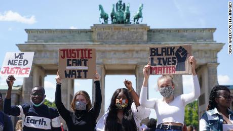 People attend a rally against racism in front of the Brandenburg Gate in Berlin on Sunday. 