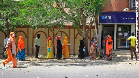 People wait outside the bank when locked in Jaipur, Rajasthan, India, on April 9.