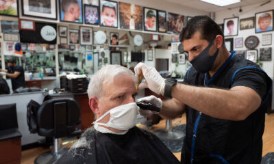 Howard Kaplan gets a haircut from Eli Gilkarov at Jack's Barbershop, on June 9, in Larchmont, New York.
