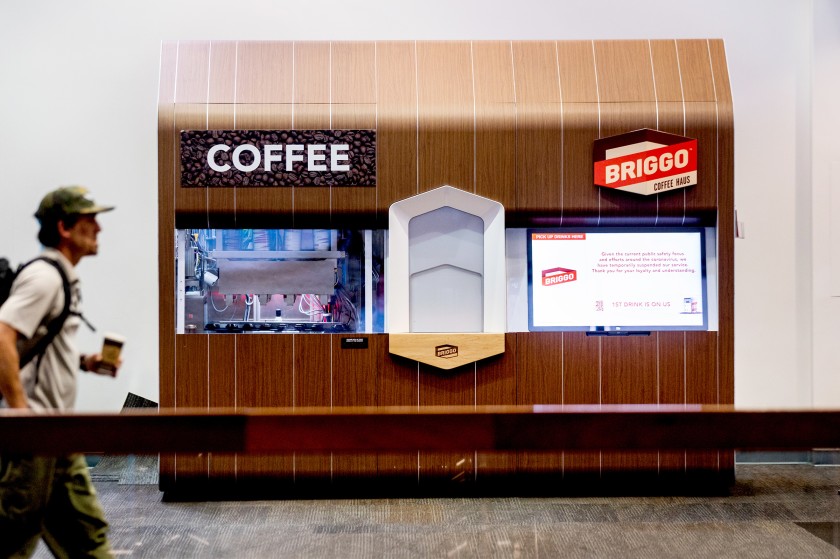 A traveler passes by the Briggo coffee vending machine at San Francisco International Airport.