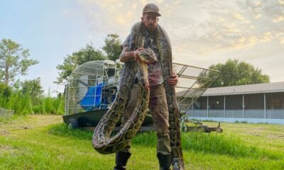 Mike Kimmel with the 17-foot python he caught draped around his neck.
