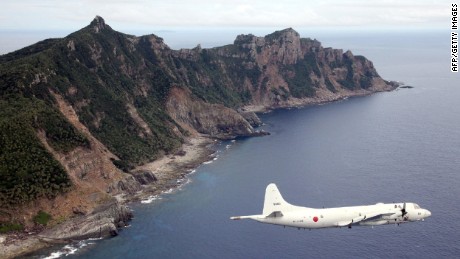 A Japanese military aircraft flying over the island of Senakuku / Diaoyu in this photo file.