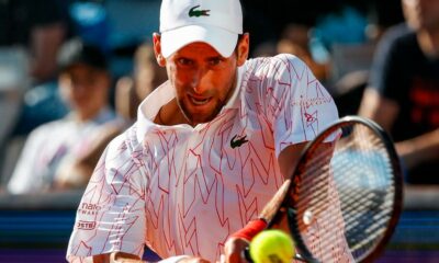 Serbia's Novak Djokovic returns the ball during an exhibition tournament in Zadar, Croatia, Sunday, June 21, 2020. Tennis player Grigor Dimitrov says he has tested positive for COVID-19 and his announcement led to the cancellation of an exhibition event in Croatia where Novak Djokovic was scheduled to play on Sunday. (AP Photo/Zvonko Kucelin)