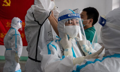 Medics prepare for their shift at the Jinrong Street testing site, in Beijing on June 24.