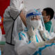 Medics prepare for their shift at the Jinrong Street testing site, in Beijing on June 24.