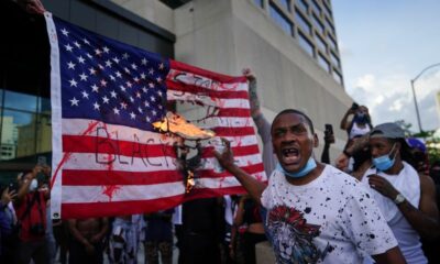 Protesters burn a flag outside the CNN Center on May 29, in Atlanta, Georgia.
