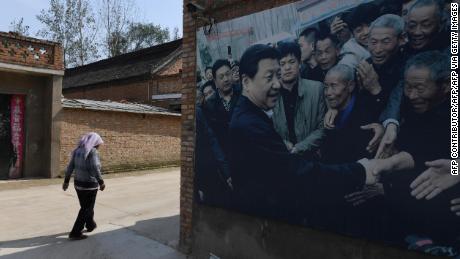 This photo taken in September 2017 shows a billboard showing a photo of Chinese President Xi Jinping visiting residents in the village of Zhangzhuang in Lankao in central Henan province of China. 