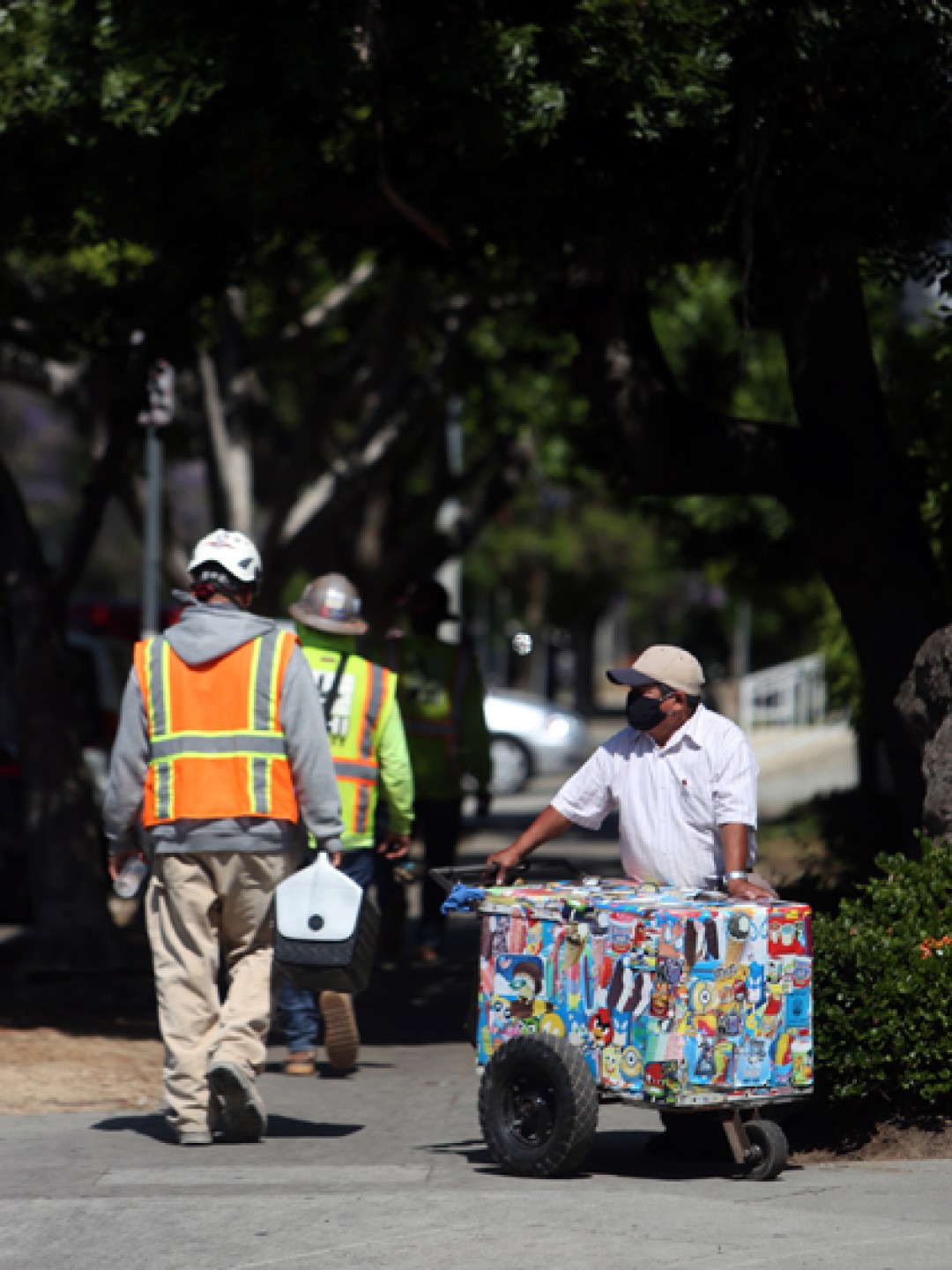 Mauro Rios Parra moves his cart near the construction site where workers sometimes buy paletas.