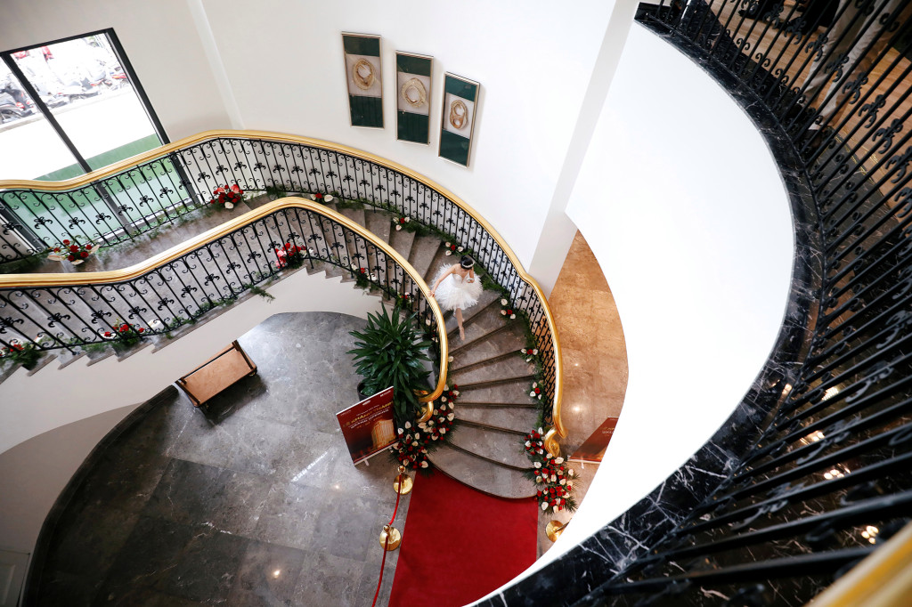 A dancer walks down the steps at the newly opened Dolce Hanoi Golden Lake hotel in Hanoi