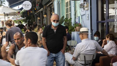 A man wearing a protective mask at a crowded restaurant in Jaffa, Israel, on May 29.