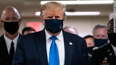 Trump wears a mask during visit to wounded service members at Walter Reed 