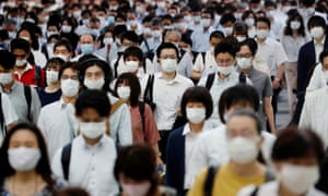 People wearing protective masks amid the coronavirus disease outbreak, make their way during rush hour at a railway station in Tokyo, Japan, 3 July 2020.