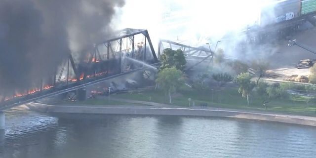 A train bridge partially collapsed after a derailment and fire in Tempe, Ariz. on July 29, 2020.