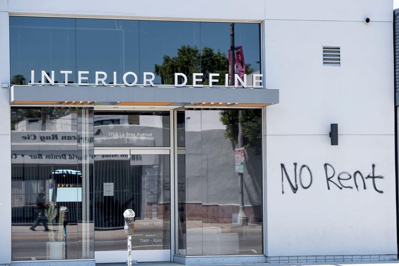 A graffiti asking for "No Rent" is seen on a wall of a building.