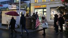 Tourists take photos of actors dressed as soldiers at former Checkpoint Charlie in Berlin, where US and Soviet tanks confronted each other in the early years of the Cold War.