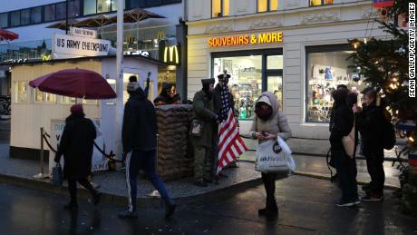 Tourists take photos of actors dressed as soldiers at former Checkpoint Charlie in Berlin, where US and Soviet tanks confronted each other in the early years of the Cold War.