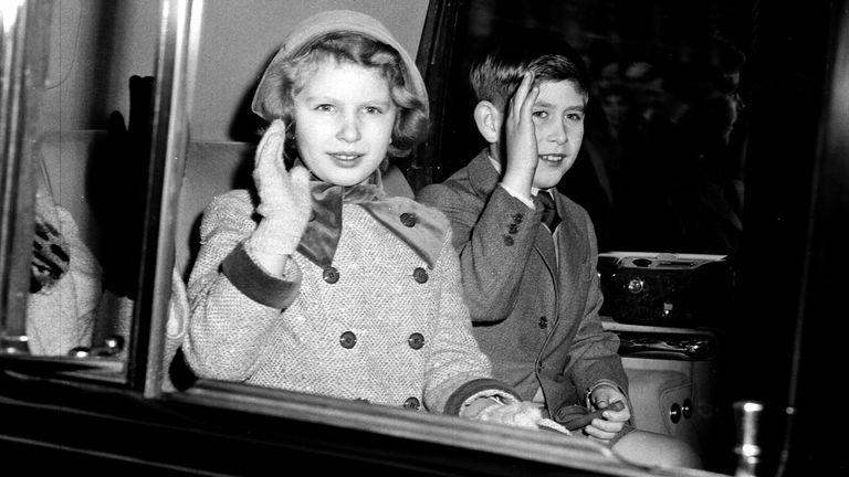 Princess Anne and Prince Charles waving at the crowds in London in 1958