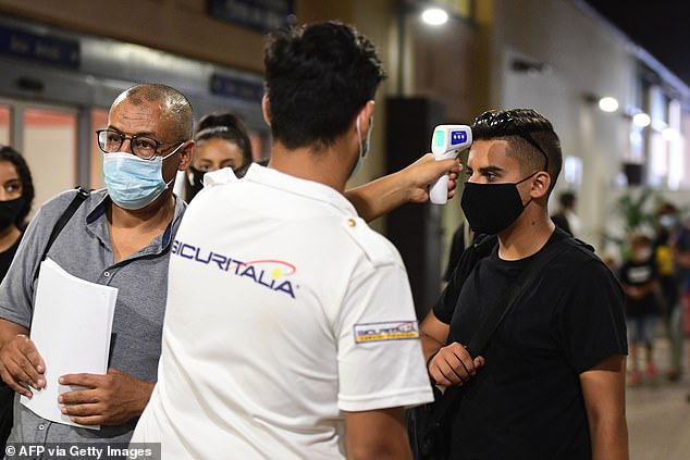 Passengers of the first cruise ship to set sail from Italy since the coronavirus lockdowns were required to have their temperatures checked, and to be tested before being allowed to board