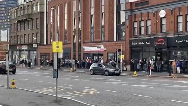 Concerned police in Leicester have been forced to use emergency powers to break up huge crowds eagerly waiting to take restaurants up on their offer. Pictured: People queuing for restaurants on London Road