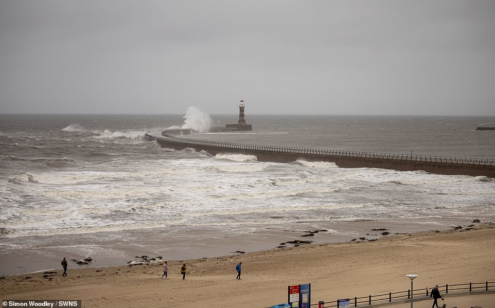 Waves slam against the pier at Roker Lighthouse in Sunderland, yesterday afternoon, as clouds roll in from the North Sea