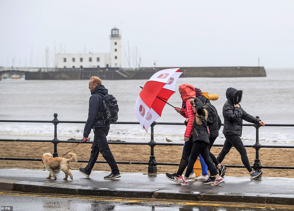Despite the grey and blustery weather, people were still seen walking along the windy seafront at Scarborough, North Yorkshire, yesterday