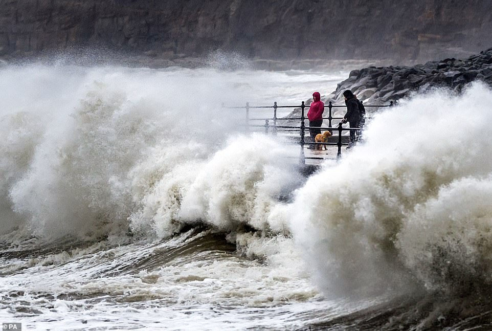 Waves were seen crashing against the seafront at Scarborough, North Yorkshire, earlier yesterday, as Britain faces a Bank Holiday washout