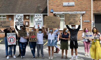 Students hold placards as they protest outside of the constituency office for Gavin Williamson, Conservative MP for South Staffordshire and Britain's current Education Secretary, in Codsall near Wolverhampton, central England on August 17, 2020, to demonstrate against the downgrading of A-level results. - The British government faced criticism after education officials downgraded more than a third of pupils' final grades in a system devised after the coronavirus pandemic led to cancelled exams. Although the newly released results for 18-year-olds showed record-high grades and more students accepted to university courses, exam boards downgraded nearly 40 percent of pupils' grades in England. (Photo by Paul ELLIS / AFP) (Photo by PAUL ELLIS/AFP via Getty Images)