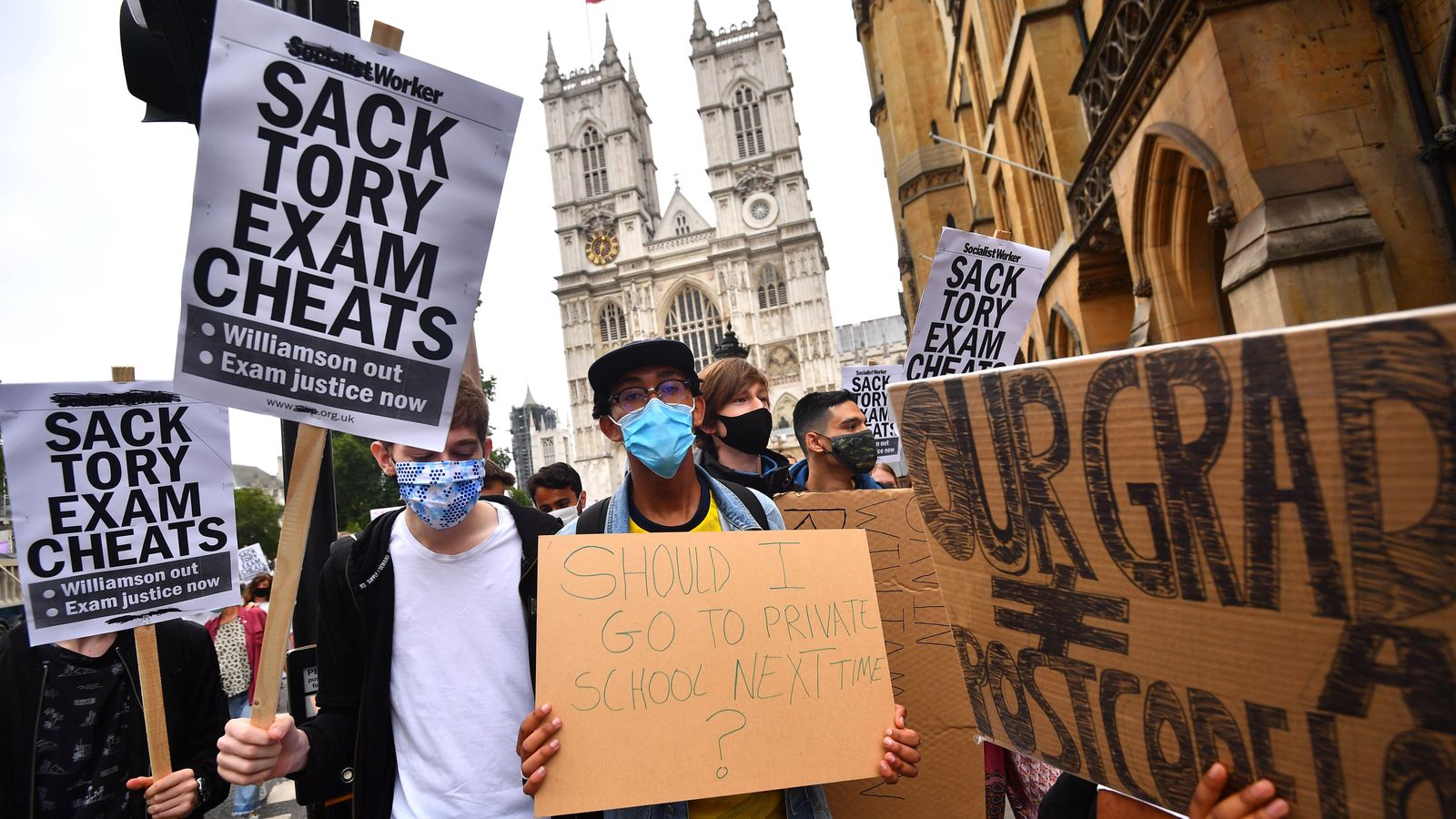 People take part in a protest in Westminster in London over the government's handling of A-level results