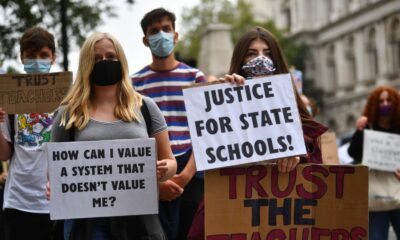 Demonstrators joining Young Socialists hold up placards outside the Department for Education, London as they protest the handling of exam results, university provision and bleak employment prospects.