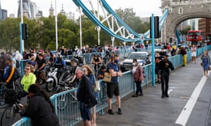 Pedestrians wait on Tower Bridge on Saturday afternoon.
