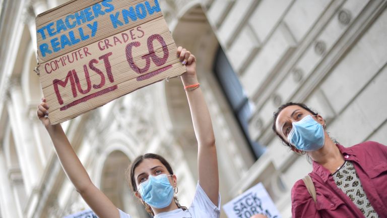People take part in a protest outside Downing Street in London over the government's handling of A-levels.  Thousands of schoolchildren across England have expressed frustration at the deteriorating results following the cancellation of exams due to the coronavirus.