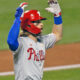 Bryce Harper of the Phillies is bailed out as he heads for his position against the Mets.