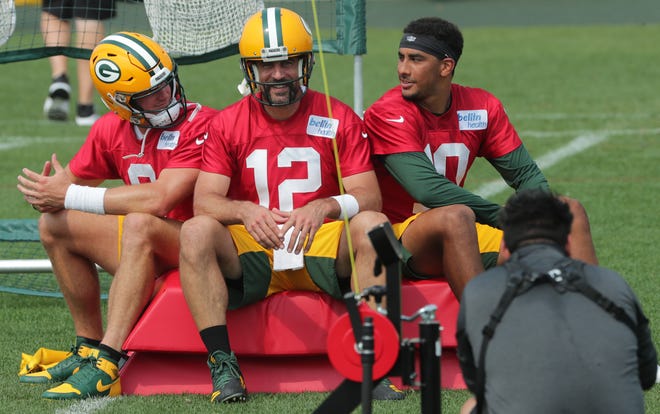 Green Bay Packers quarterback Aaron Rogers (12) is featured as defenseman Tim Boyle (left) and Jordan Love (right) on Monday 24 August 2020 during the team's training camp at Ray Nitschke Field in Ashwaubenon.
