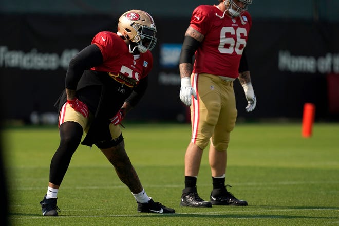 San Francisco 49ers' Trent Williams (left) warms up during NFL training in Santa Clara, California, Tuesday, August 18, 2020.