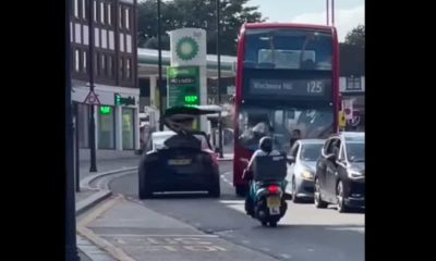 Tesla.  The video shows a Model X with an open door crashing into a bus