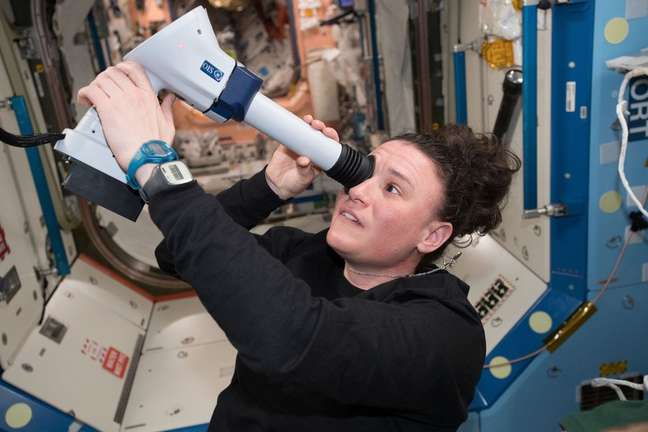 Astronaut Serena Auñon-Chancellor examines her eyes with a device called the Funduscope on the International Space Station.