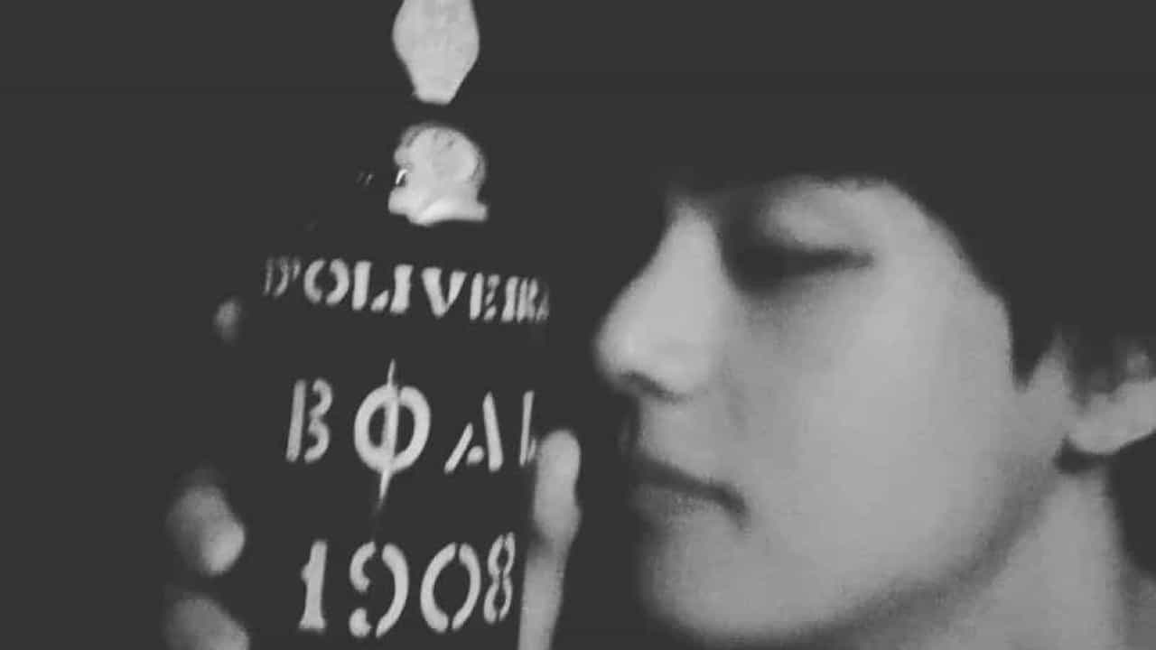 The BTS singer poses with a thousand euro bottle of Portuguese wine