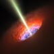 A black hole launches a jet of matter into a neighboring galaxy